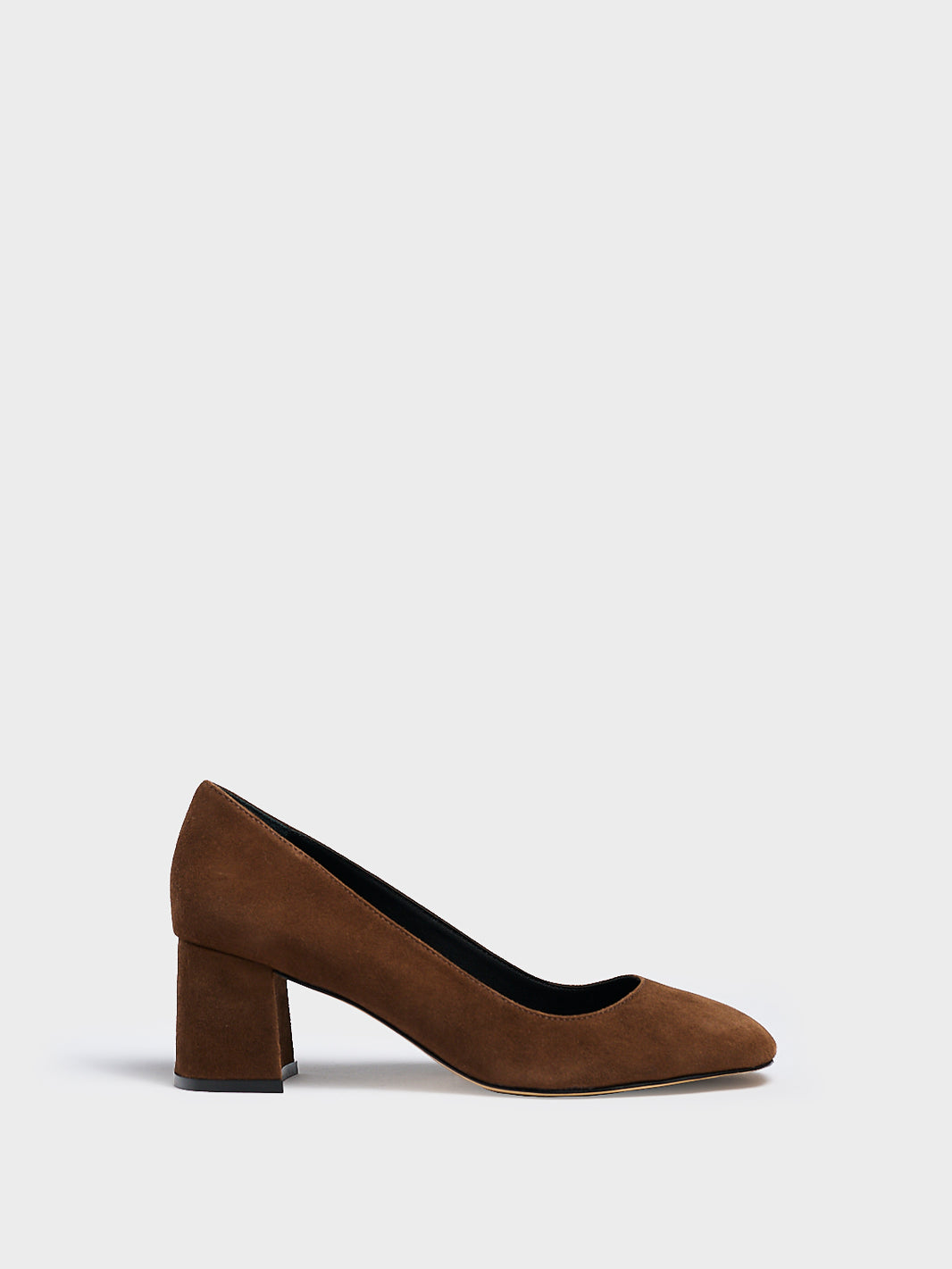 Profile view of a mocha brown suede block heel pump with a rounded toe.