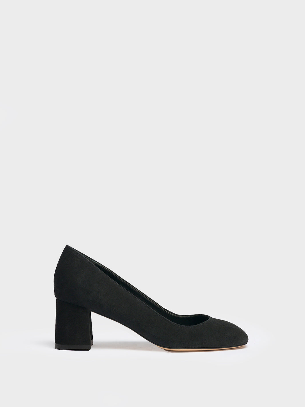 Profile view of a black suede block heel pump with a rounded toe.