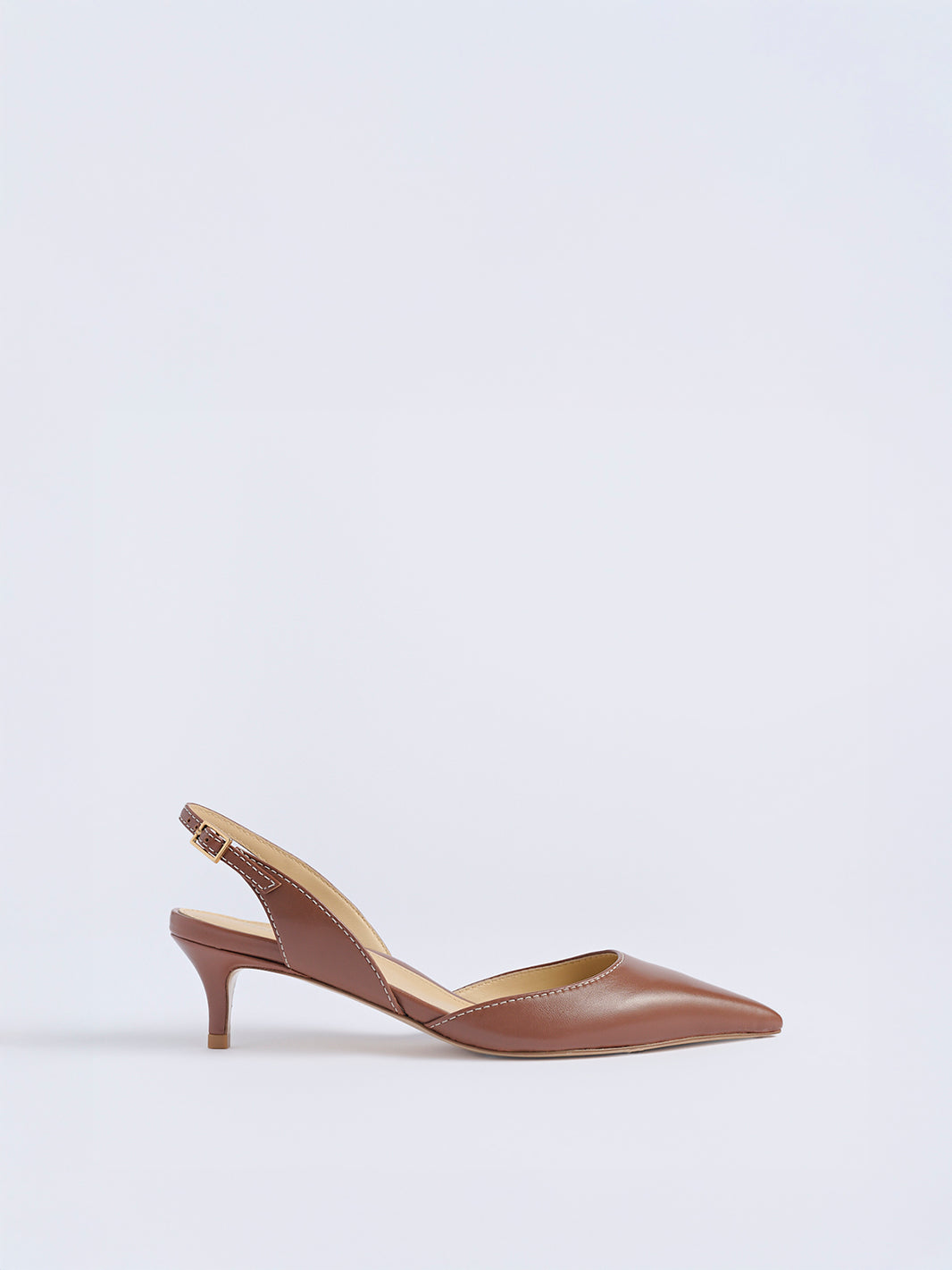 Profile view of a luggage leather slingback heel with a pointed toe