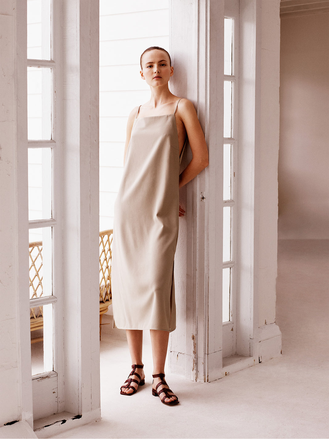 Burgundy leather gladiator sandal with an adjustable ankle strap, shown on a model.