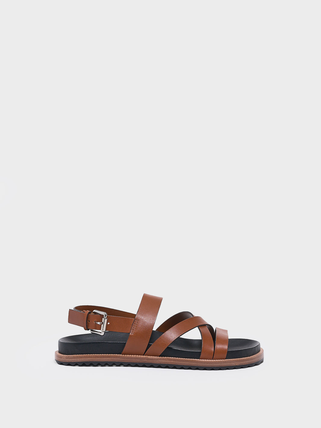 Profile view of a chestnut leather molded footbed slide sandal with an adjustable back strap.