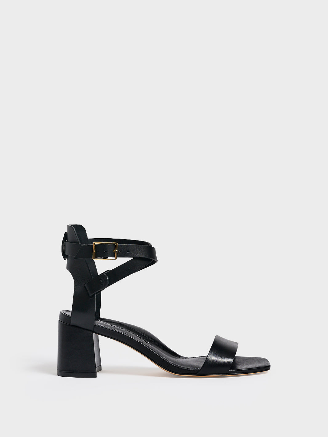 Profile View of a black leather block heel sandal with an adjustable ankle strap design.