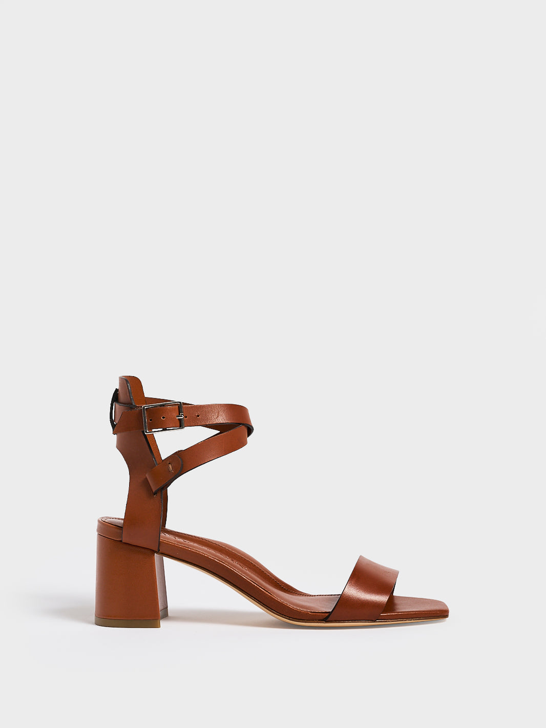 Profile View of a chestnut leather block heel sandal with an adjustable ankle strap design.