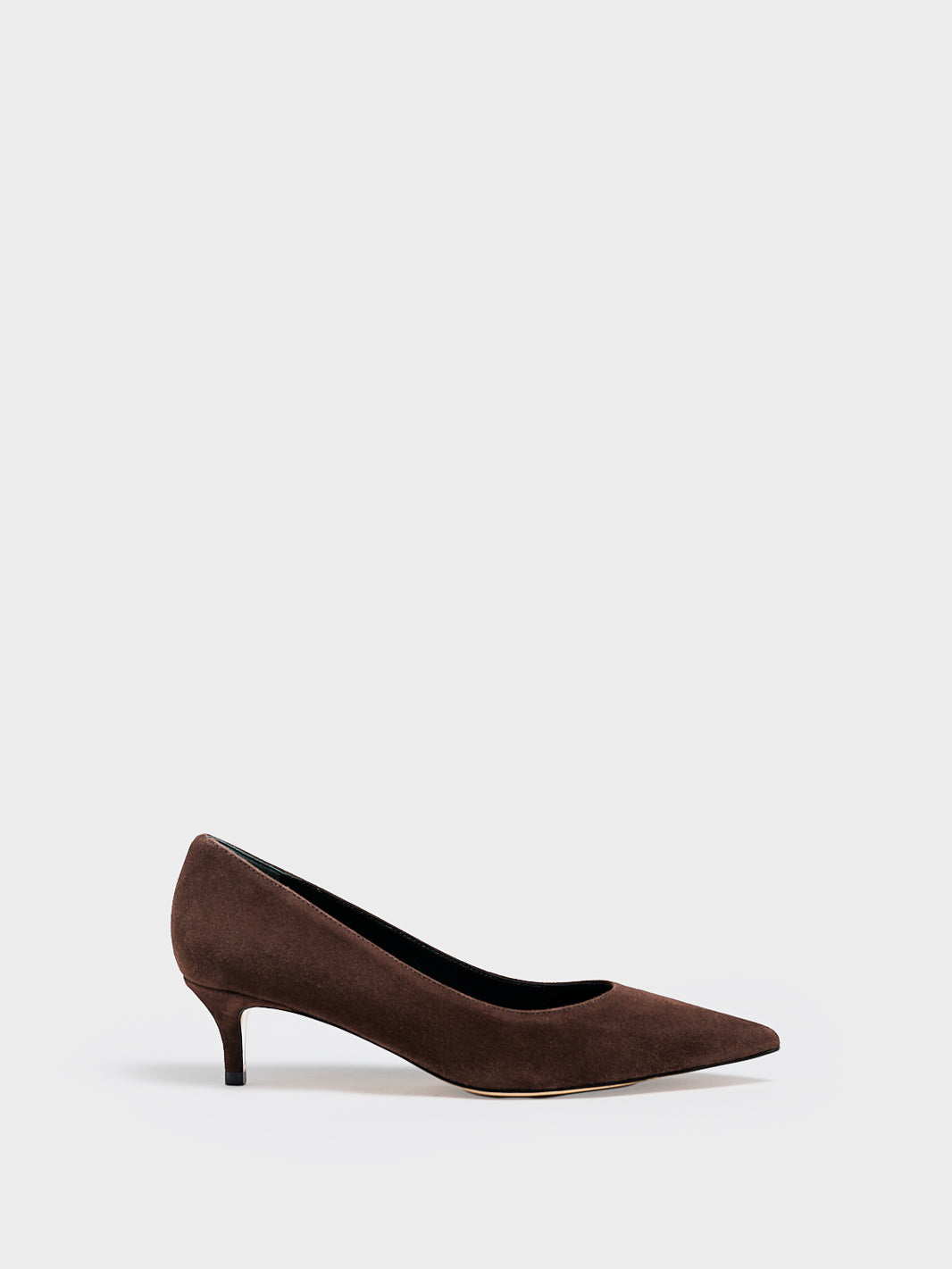 Profile view of a chocolate suede kitten stiletto heel pump with a pointed toe.