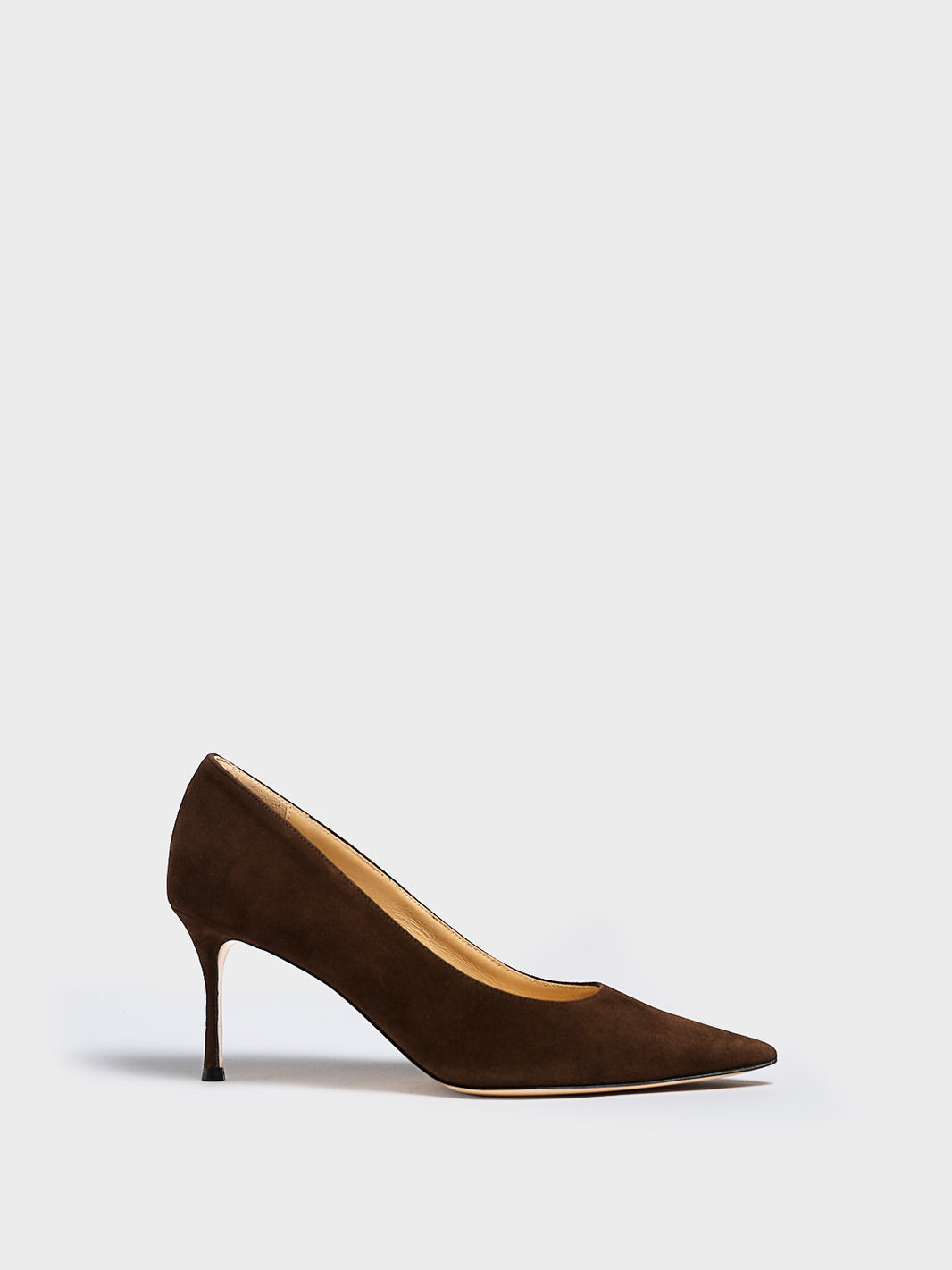 Profile view of a chocolate suede stiletto heel pump with a pointed toe.