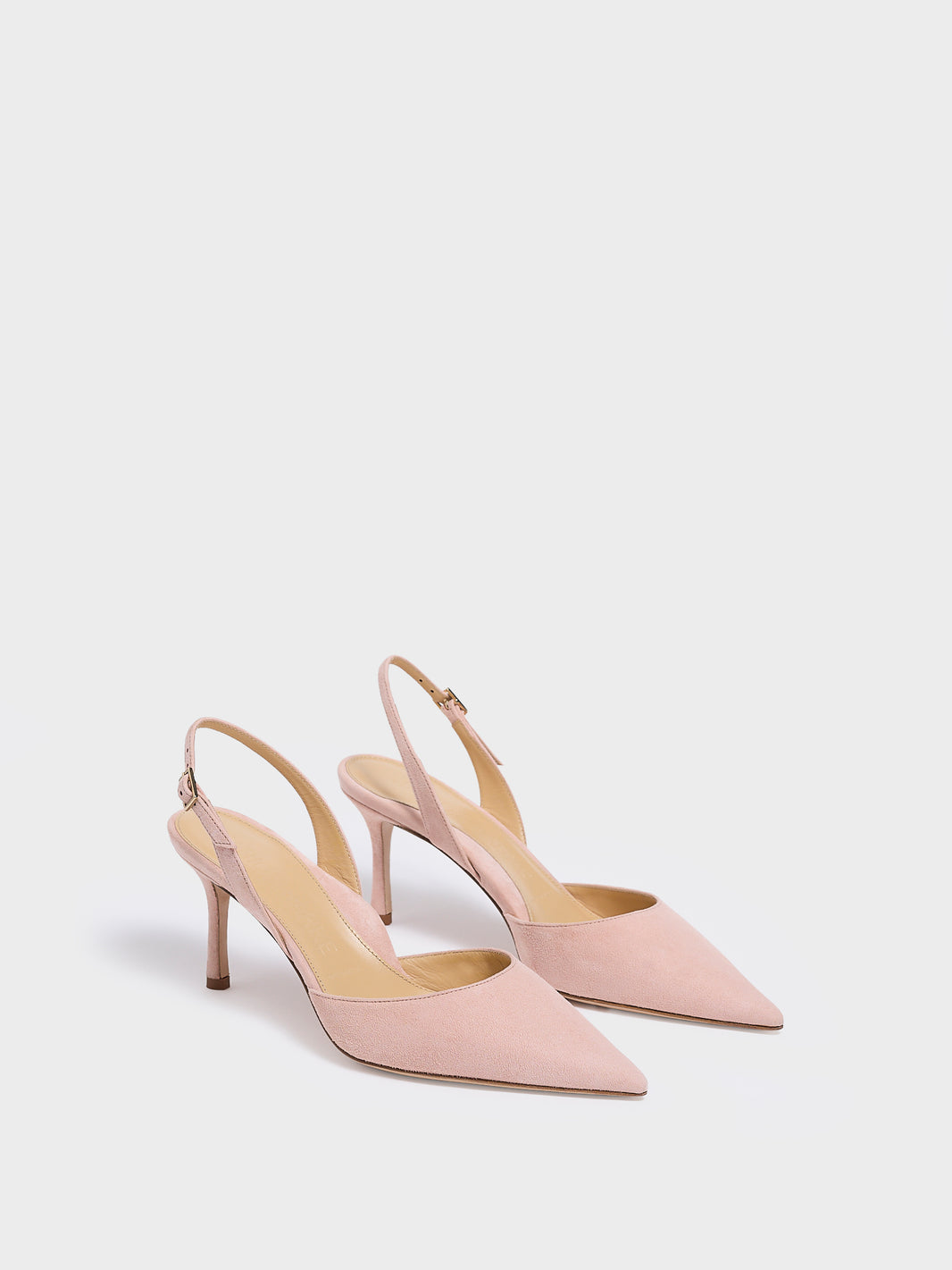 Angle view of a pair of powder suede slingback heels with a pointed toe