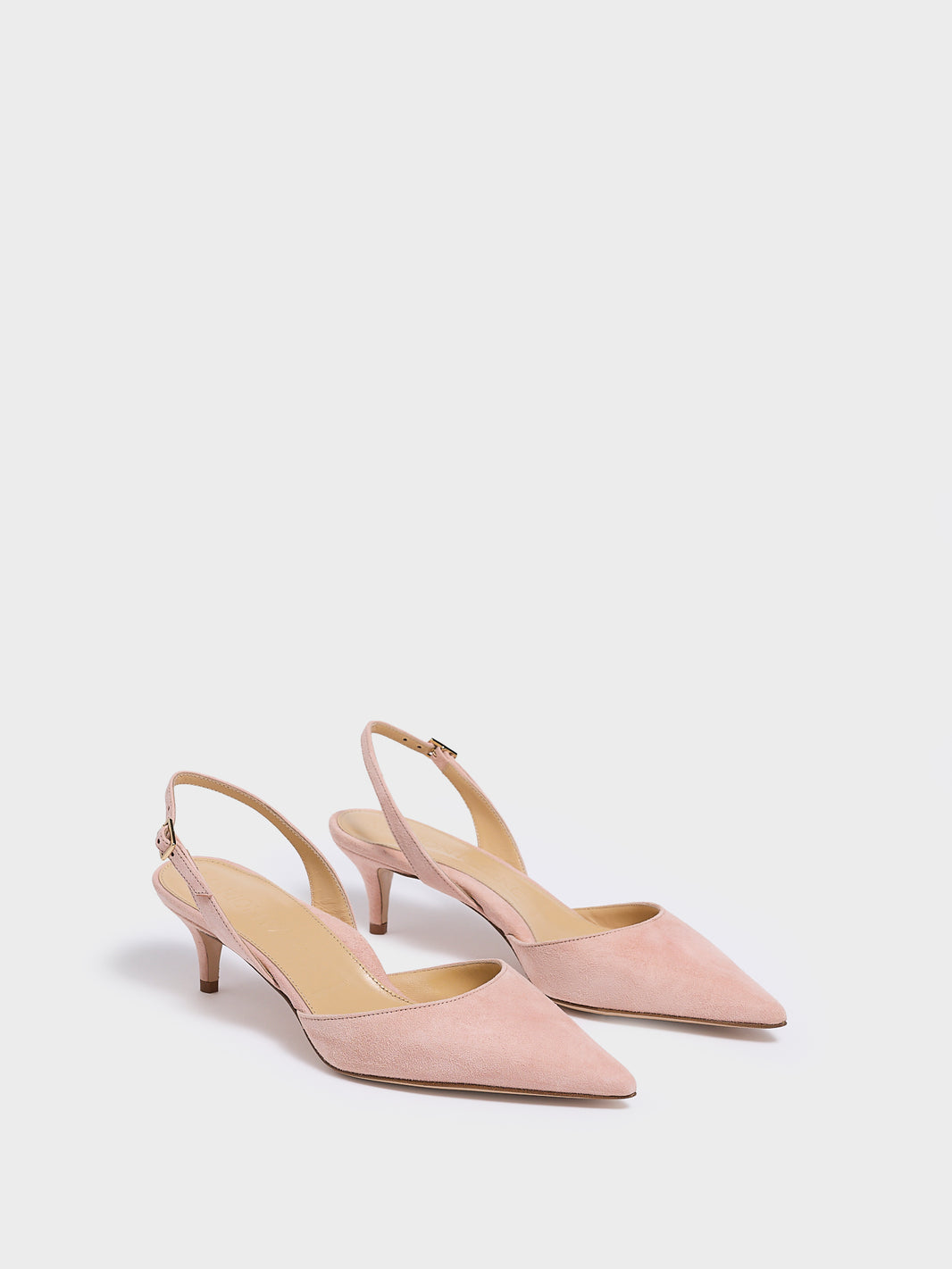 Angle view of a pair of powder suede slingback kitten heels with a pointed toe