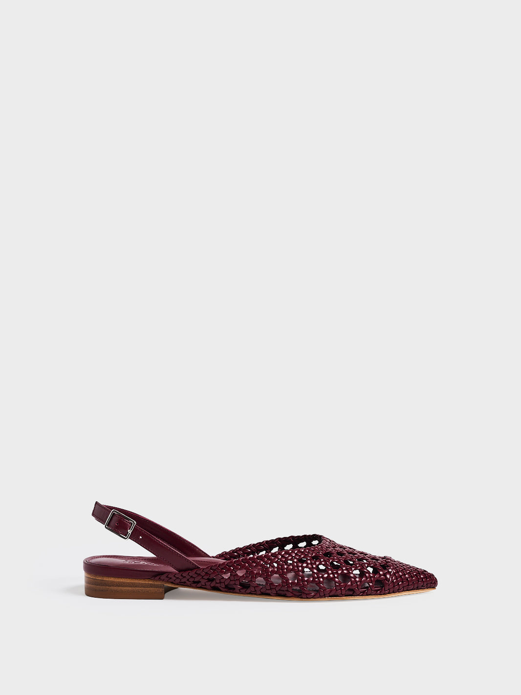 Profile view of an burgundy braided leather slingback flat with a pointed toe