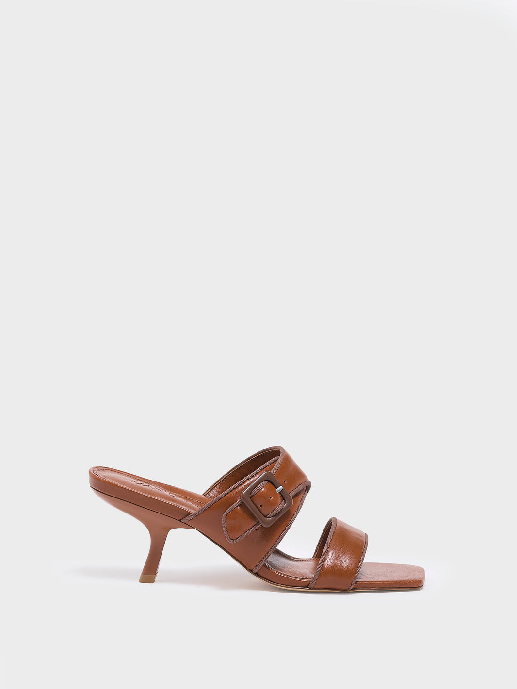 Profile view of a chestnut leather slide kitten heel sandal with a buckle detail.